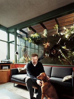 Farnham and Kasia sit in front of the home’s most impressive feature: an enclosed atrium overlooking the living area. In 2007, Dale Loughins outfitted the atrium with all manner of exotic epiphytes and an automated misting system.