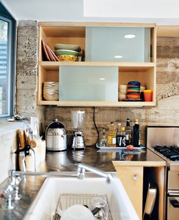 How This Couple Broke The Rules in a LA Suburb - Photo 3 of 9 - There are precious few decorative flourishes in the house; the architects put their faith in line, form, and materials. Concrete, stainless steel, and birch were used in the kitchen, where not an inch of space goes unused.