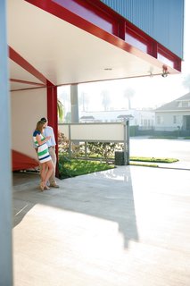 The house is quite vertical, but Cooper, with boyfriend Tonu Mets, designed it with an eye toward outdoor spaces like carport shown here and the fire pit out back.