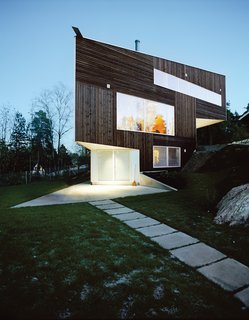 The Triangle House was completed in 2006, and its natural materials and geometric form equally embrace the surrounding forests and ocean. Image by Ivan Brodey.