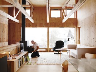 Knotty by Nature - Photo 11 of 25 - Bornstein’s living room features an intriguing collection of furniture. The sofa is made by Swedish manufacturer Ire. The 1970s wood burner was a secondhand store find, and the wood table, by Bruno Mattson, was found in a bin at a recycling station. He inherited the lounge chair from his parents.