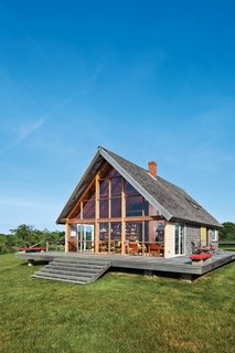 Jens Risom's Block Island Family Retreat - Photo 11 of 13 - On the north-facing facade, it’s easy to discern where the original glass doors used to open directly to the deck. In spring of 2012, Block Island contractor John Spier replaced the entire wall of glass panels.