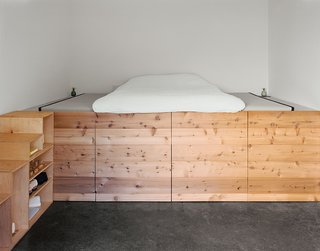 Abandoned Industrial Compound Becomes a Modern Home Base - Photo 5 of 11 - The couple’s bedroom, occupying a space that was once a machine shop, has a cedar sleeping platform designed and built by Elliot Loh.