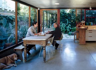 The couple relax in their open-plan kitchen with their twelve-year-old lab, Uma.