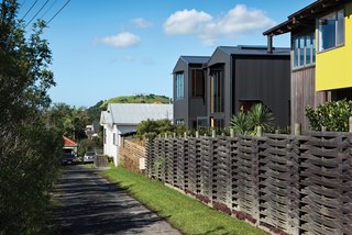 With its pitched roof and verticality, the house blends with the surrounding seaside neighborhood yet remains architecturally distinct thanks to its aluminum cladding.