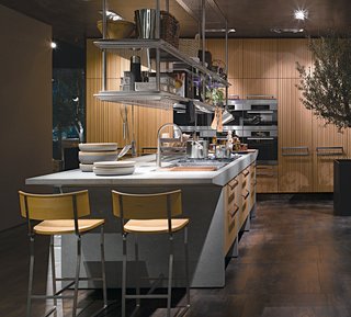 Arclinea's Lignum and Lapis kitchen system features green materials, professional-grade appliances, and advanced technology like a miniature greenhouse for growing herbs indoors and a retractable glass hood over the cooktop.