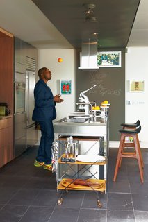 Architect David Anand Peterson designed the custom millwork and shelving in Montague’s kitchen. The stainless steel island is by Bulthaup. The stools are vintage and were designed by Erik Buck. Montague was thrilled to spot the same ones adorning Don Draper’s apartment in the latest season of Mad Men.