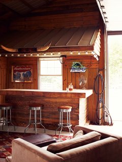Inside, Paul often dispenses whiskey to friends from behind the rustic bar.