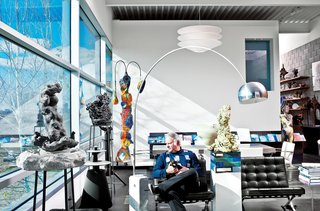 A longtime collector of furniture and art, Dr. Robert Geller finally lives among his prized possessions. In the living room, he sits on a Barcelona chair by Mies van der Rohe for Knoll. To his right are an Arco floor lamp by Achille and Pier Giacomo Castiglioni for Flos and a BeoLab 5 speaker from Bang & Olufsen. The sculptures to Geller’s left and in the foreground are by American artist Arlene Shechet, Everything Seems to be Something Else and Just Remembered.