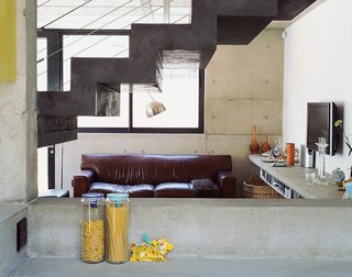 Caryn was thrilled to discover that all her personal details look spectacular when offset against the solemnity of concrete. In profile, the freestanding staircase is the most outstanding design accent.