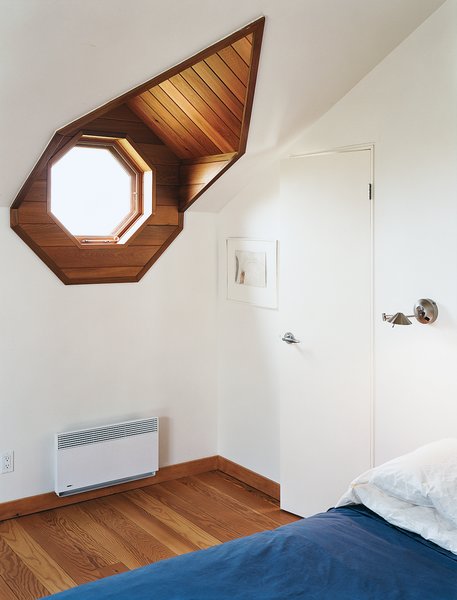 The porthole window in the master bedroom not only evokes the sea, it looks out onto it.