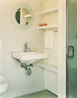 In the guest bathroom, penny tiles were chosen "because they’re incredibly economical, utilitarian, and we liked their kitschy feel," explains Gaffney.