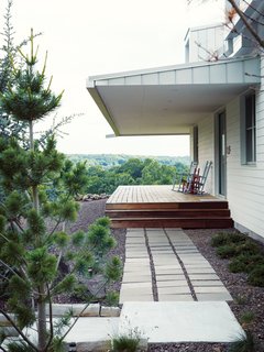 MODERN TAKE ON A TRADITIONAL FARMHOUSE IN MISSOURIThanks to Matthew Hufft, their envelope-pushing architect and longtime friend, Hannah and Paul Catlett have a new home in southwestern Missouri that’s a fresh, unconventional take on the traditional farmhouse. The homeowners call the house Porch House after it's majestic wraparound porch.photos by: Joe Pugliese