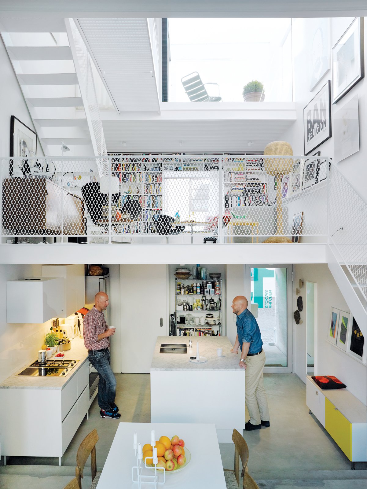 Three thin slabs, staggered vertically through the space, create three distinct floors and allow light to flood in from the front, back, and roof. The white Saari kitchen makes the most of a compact space.