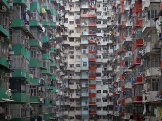 Megacity Living in Hong Kong: Architecture of Density - Photo 2 of 7 - From a distance, the buildings resemble geometric patterns. However, close inspection reveals laundry, mops and other signs of domestic life. Photo by Michael Wolf, courtesy of the Flowers Gallery.