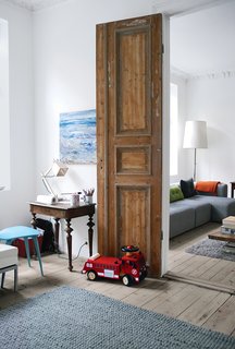 10 Creative Uses of Reclaimed Wood - Photo 10 of 10 - The goal of the renovation was to get the most out of every square inch, since there was no way to expand beyond the apartment’s historic envelope. Always-open double doors—stripped down to their original wood—connect the railroad-style parlors to create an open, loft-like feel.