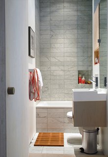 Budget-Friendly Renovation of a Neoclassical Home in Oslo - Photo 6 of 11 - The 22-square-foot bathroom had no windows, which is common in Oslo apartments; new clerestory windows help illuminate and expand the space.