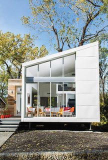 10 Homes With Distinctive Facades - Photo 5 of 10 - The house that Kem Studio designed for Sarah Magill on a narrow lot in Kansas City has a steel facade with reclaimed cypress cladding near the entrance. The entire structure sits atop a steel foundation set on concrete piers that were driven into solid stone.
