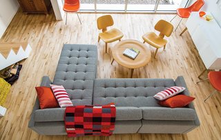 10 Warm Wood Floors - Photo 1 of 10 - A Dual Pebble tufted sectional by Gus Design Group for CB2 is the focal point of this living space. The maple floors are composed of inexpensive "shorts" that were left over from other projects and sold at a discount.