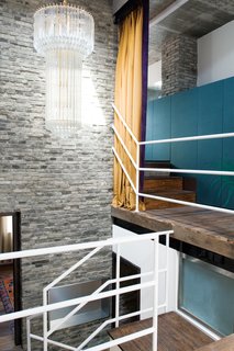 Modern Lilong House Renovation in Shanghai - Photo 6 of 11 - Carbone custom-designed the silk-covered closets along the stairwell and hung a yellow silk curtain to screen the bedroom level from light and noise.