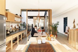 These Shop Owners Have a Killer Apartment Right Upstairs - Photo 1 of 10 - Studio Junction transformed a two-story apartment above Mjölk, Juli Daoust and John Baker’s design boutique on Toronto’s busy Dundas Street West, into a tranquil space. A courtyard joins the living room and the open kitchen and dining area.