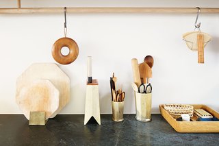 These Shop Owners Have a Killer Apartment Right Upstairs - Photo 3 of 10 - A cherry pot trivet by Oji Masanori hangs from a white-oak kitchen rail by Studio Junction above a custom soapstone counter-top.