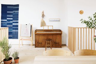 These Shop Owners Have a Killer Apartment Right Upstairs - Photo 2 of 10 - An antique Japanese indigo tapestry hangs by a vintage Danish piano.