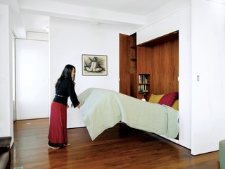 "We wanted to keep the exterior walls uncluttered, so you can focus on the views, the light, and the air," says Rosa. To achieve a clean slate, everything gets tucked away, including the mattress and bedding.