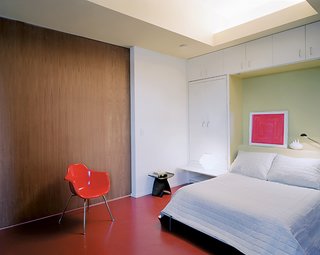 Urban Usonian - Photo 4 of 5 - A folding bed and pullout bedside tables make the transition from photography studio to bedroom painless.