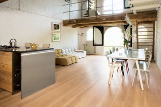 The deceptive simplicity of the dining table and chairs, by Piet Hein Eek, and Tufty Time sofa by Patricia Urquiola for B&B Italia, enhance the authentic feeling created by the old gallery-style middle floor, supported by massive 400-year-old beams.