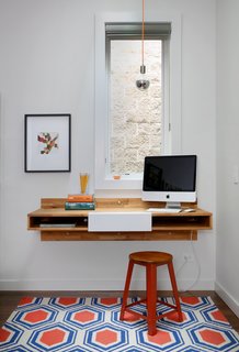 A Mash Studio Wall-Mounted desk offers a place to study. The rug is from One King’s Lane and a SoCo Modern Socket pendant illuminates the room.