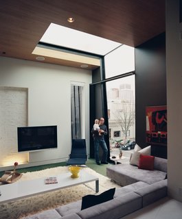 WestEnders - Photo 3 of 8 - In the living room, a double-height window and a skylight work together to frame a view of the Victorian Gothic church just across the street.
