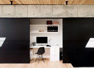 A Texas Couple Builds Their Cast-In-Place Concrete Dream Home - Photo 8 of 17 - Located off of the kitchen, Vivi’s office disappears behind sliding walls covered in black chalkboard paint from Behr.