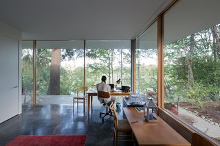 "There are a lot of well-loved, well-used pieces that were destined for this house," Andrea says of the couple’s furniture collection. They placed a solid alder Homestead table from Whittier Wood Furniture in the office, which also overlooks the pond.