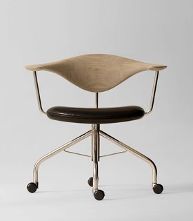 During a Danish furniture trade show, Dr. Eigill Snorrason critiqued the industry for not paying enough attention to ergonomics. The Swivel Chair (1955) Wegner’s rejoinder of sorts, an elegant backrest of hand-carved wood that’s been compared to a gently bent propeller. The smooth lines, thin profile and wheels invite a sure-footed slide across any office. Manufactured by PP Møbler. Photo by Jens Mourits Sørensen.