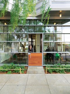 Just Redo It - Photo 7 of 9 - Dunbar and Astrakhan's low-cost, high-impact tour de force is a storefront facade constructed from salvaged double-insulated window glass panels arranged in a shingle pattern.