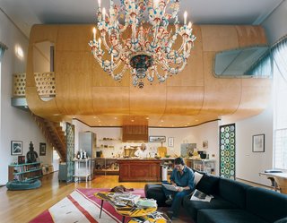 With the free-floating birch pod defining the space, and the massive Venetian chandelier accentuating the volume, the great room is, indeed, great. The Suarezes wanted the living area to be a place where the family could be occupied individually while still together. Bonnie works in the kitchen while Santiago (seated on an IKEA couch borrowed from one of their sons until they find something else) works on the computer.