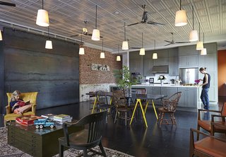 In Auburn, Alabama, architect David Hill purchased a historic brick building that had served as a Baptist church, pool hall, and barbershop. When renovating the space's interior, Hill made an effort to retain its large, open spaces, and carefully restored the original metal ceiling tiles.