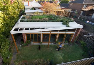 Emilio Fuscaldo sits in the garden outside the brick house that he designed for himself and his partner, Anna Krien, on a small subdivided lot in Coburg, a suburb north of Melbourne, Australia. Photo by Nic Granleese.