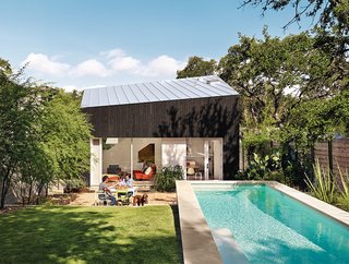 1920s Bungalow Plus Modern Addition Equals Perfect Austin Home - Photo 2 of 11 - Shah, Suttles, and their daughter, Tesla, use their outdoor space as an extra room. Near the pool is a seating area with Bistro chairs from Fermob.