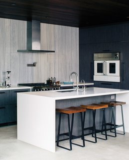 10 Open Kitchen Solutions That Will Get Things Cooking - Photo 1 of 10 - In this sleek kitchen, the range and wall oven are by BlueStar, the hood is from Zephyr, and the island is Caesarstone.