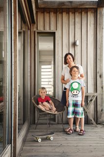 Marston (on the porch with sons Eddie, left, and George) designed the new brick house to reference outbuildings on the property.