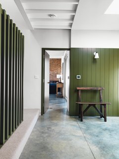 Bold color continues in the entrance hall. The bench is from an antiques fair.