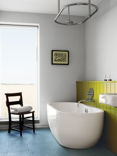A Lisbon freestanding tub and "a church chair from a junk shop" complete the children’s bathroom.