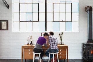 Brandon and Amy set up different workstations in the living area.