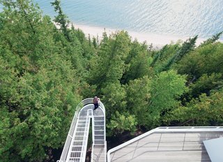 Located on the shore of Lake Michigan, the 1973 Douglas House was one of architect Richard Meier’s first residential commissions. Defined by its verticality, the house features an exterior stepped walkway that extends over the trees, connecting the levels.