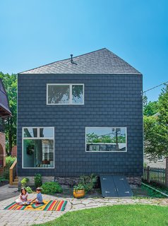 This Farmhouse-Style Home Gets a Clever and Geometric Update - Photo 1 of 5 - A couple in Evanston, Illinois, asked John Issa of Perimeter Architects to add on a two-story, 650-square-foot addition to their traditional farmhouse. The new volume is clad in composite slate siding by Inspire Roofing Products; the windows are Pella.