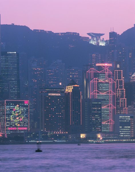 The Hong Kong skyline, including the HSBC building designed by Foster + Partners (foreground) and the Peak Tower designed by Terry Farrell (illuminated at top). Image courtesy of the Royal Institute of British Architects.