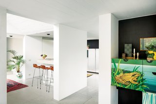 A Concrete Home in Rural Belgium - Photo 1 of 9 - Vandemoortele worked with designer Renaud de Poorter on the interior renovations, which included opening up the heavy structure with the help of new windows and doors to the outside. They didn’t want to gut the space, and kept existing decorative motifs like the dining room’s circa-1975 painted cupboard.