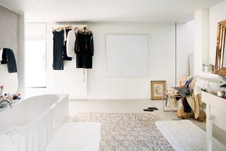 A Concrete Home in Rural Belgium - Photo 8 of 9 - In the split-level master suite, a bathroom and dressing area are situated under a combination sleeping area and lounge (above), which look onto the garden.